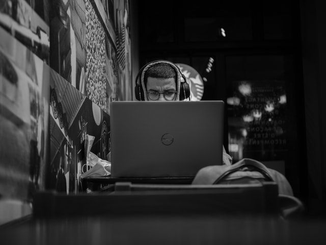 Man listening to a podcast on his laptop