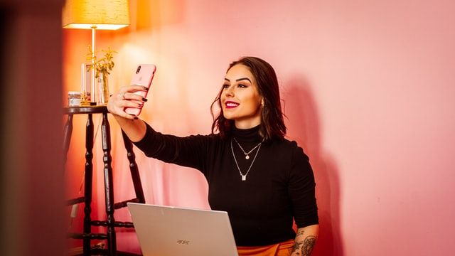 Woman influencer taking a selfie 
