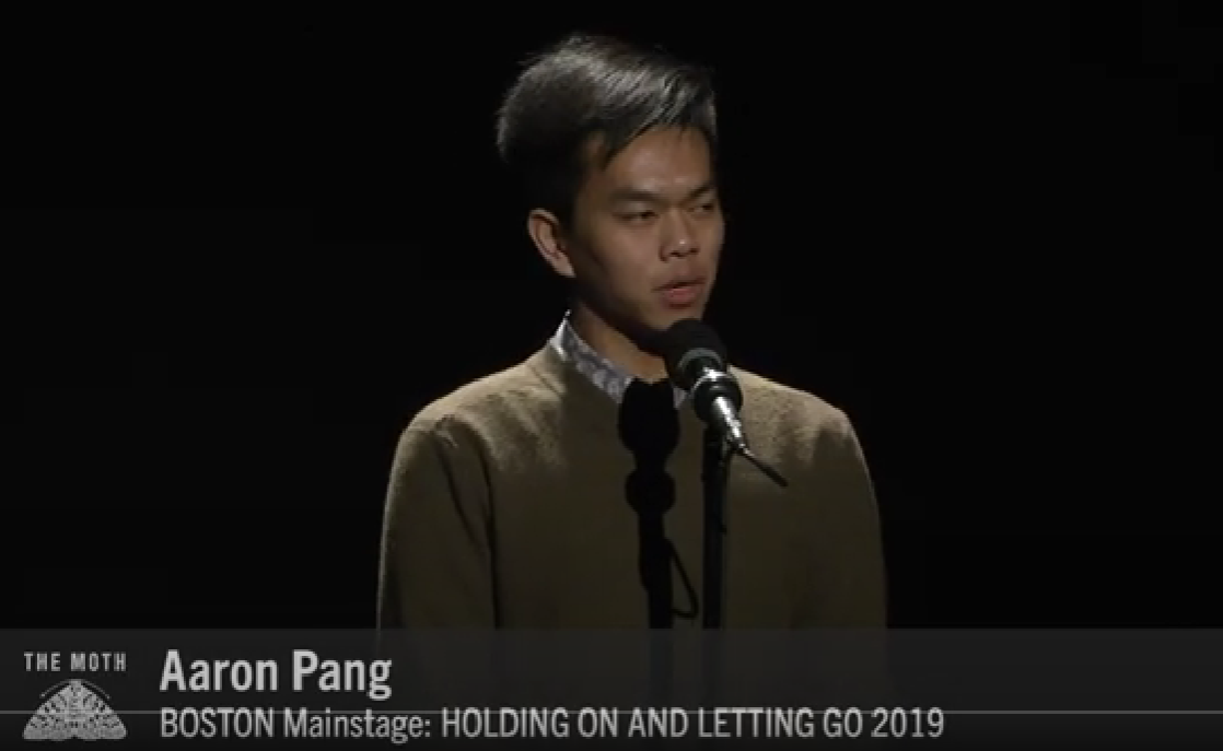 Aaron Pang speaking into a microphone